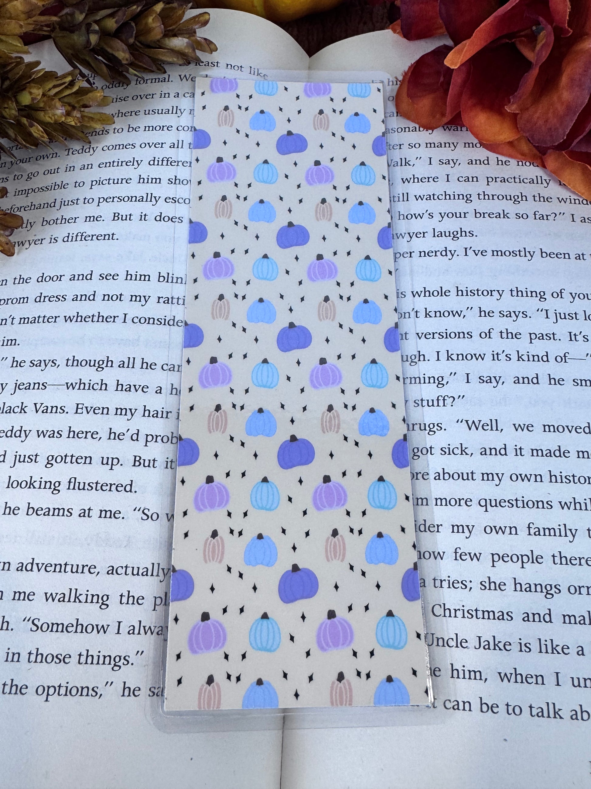 Handmade laminated bookmark featuring a hand-drawn pastel pumpkin pattern — cozy fall reading accessory for book lovers.