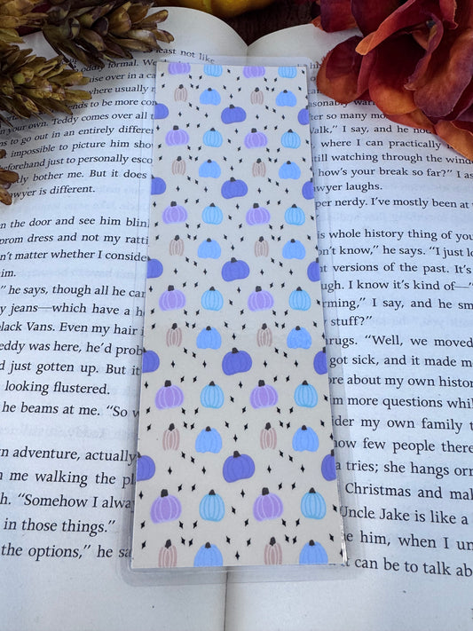 Handmade laminated bookmark featuring a hand-drawn pastel pumpkin pattern — cozy fall reading accessory for book lovers.