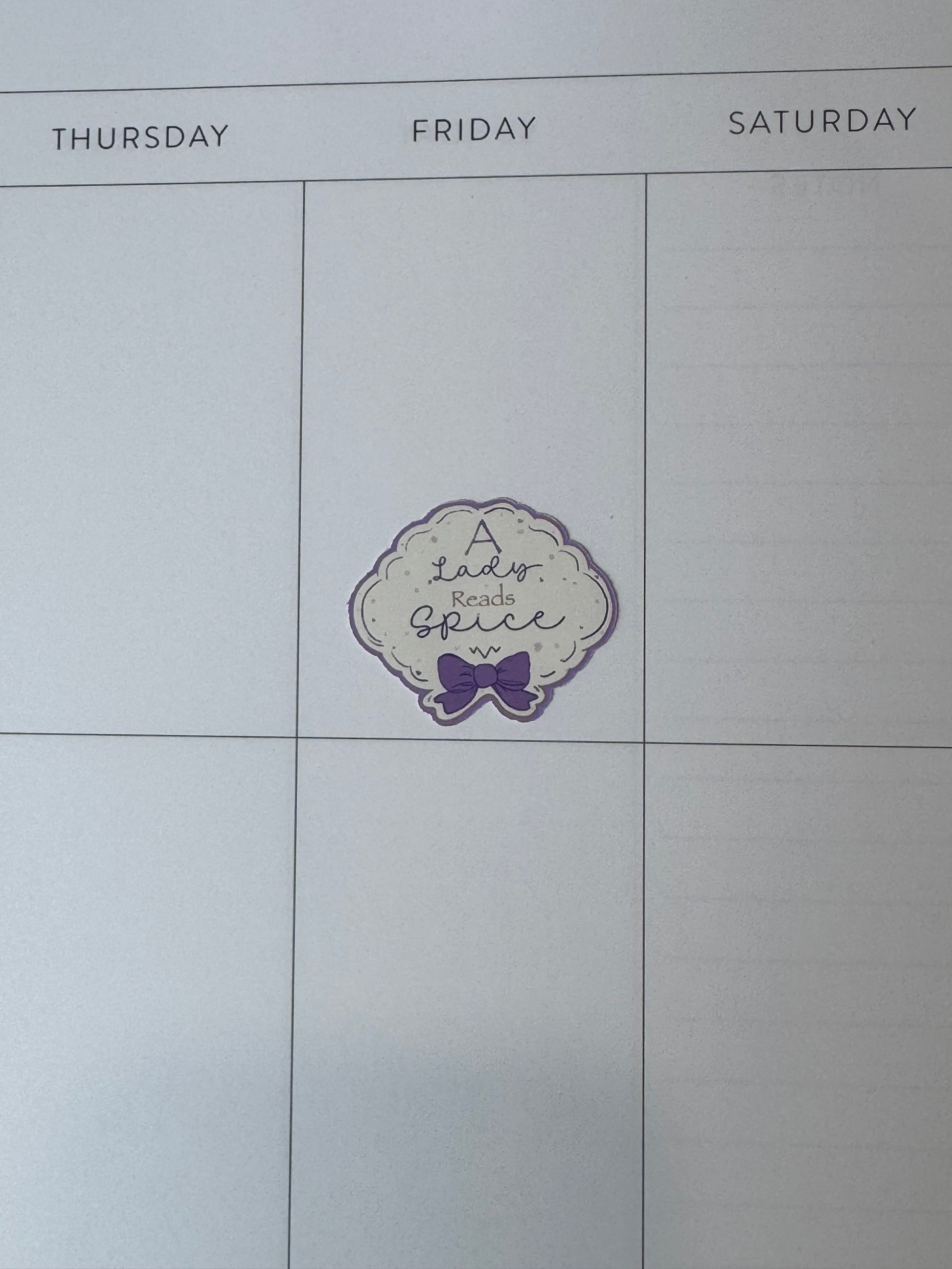 1.5 inch "A Lady Reads Spice" feminine sticker on a planner page